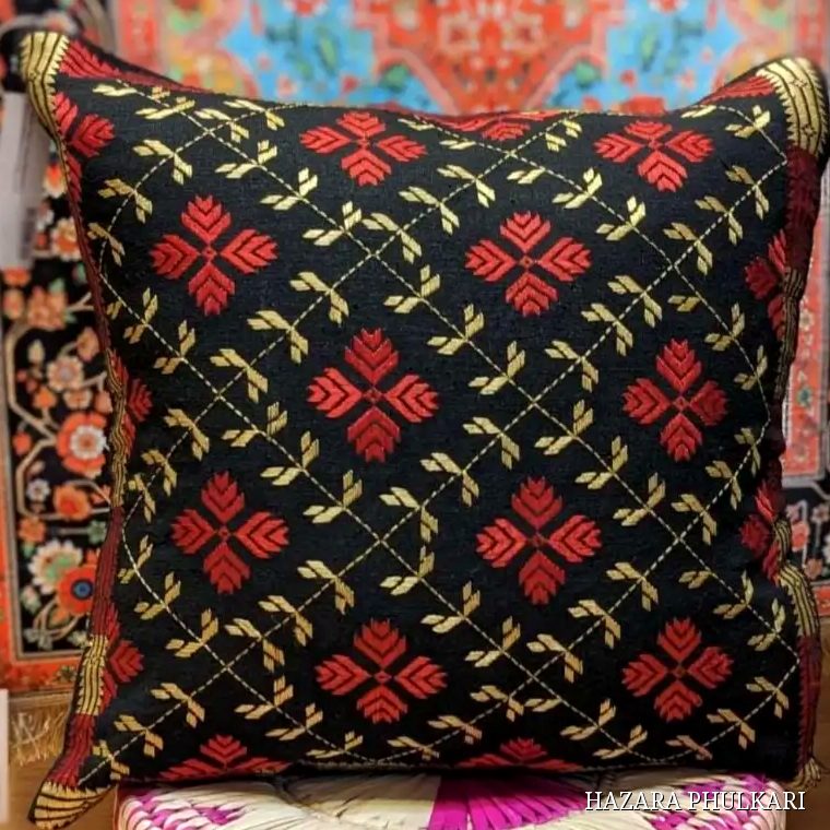 Handmade Phulkari cushion cover embroidered in red and golden thread with floral motifs on a black diamond lattice ground