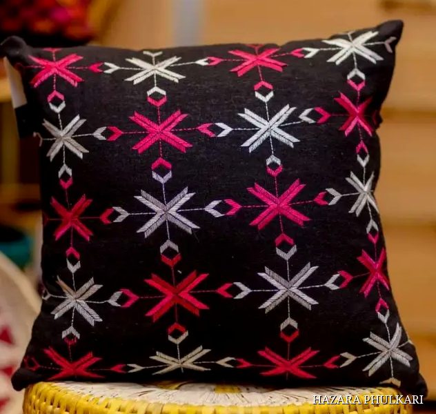 Black Phulkari cushion cover embroidered with pink, magenta and ivory star motifs in counted-thread work