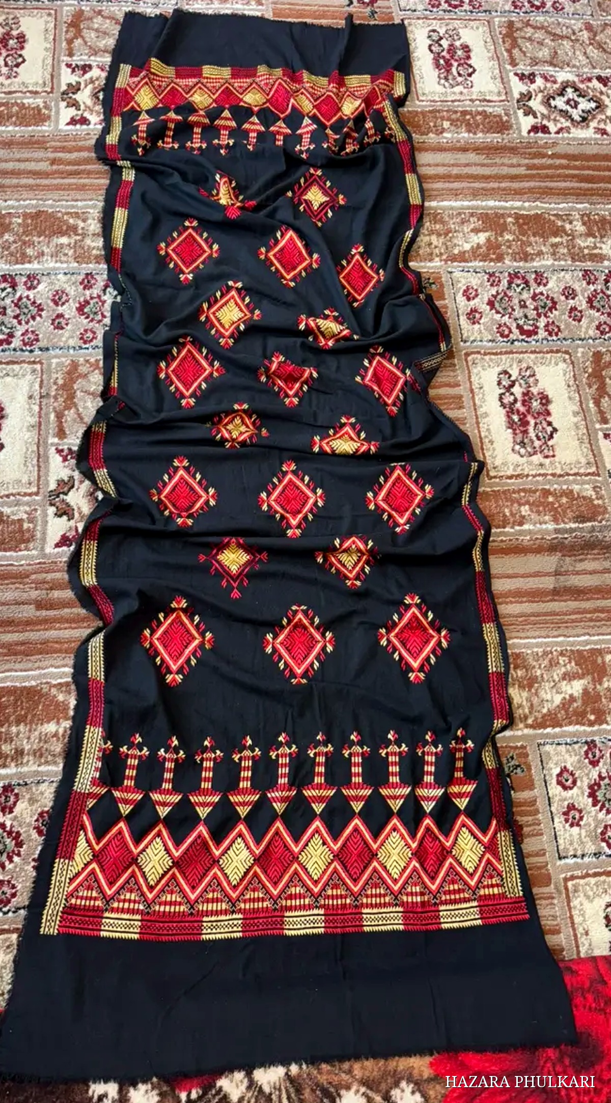 Handmade black Phulkari stole embroidered with red and golden diamond motifs and a wide zig-zag border