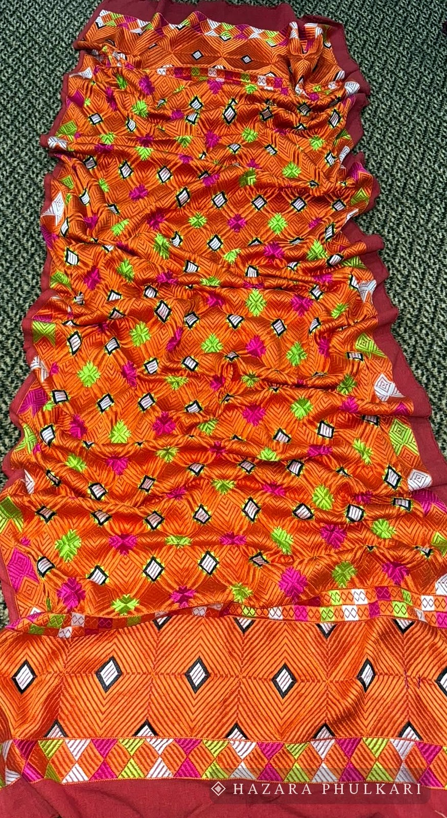 Handmade Phulkari shawl in orange with scattered floral motifs and an embroidered border