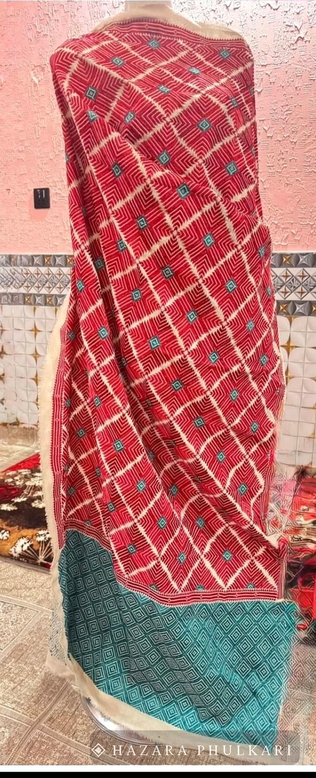 Handmade Phulkari shawl draped to show a red lattice pattern with a teal embroidered panel