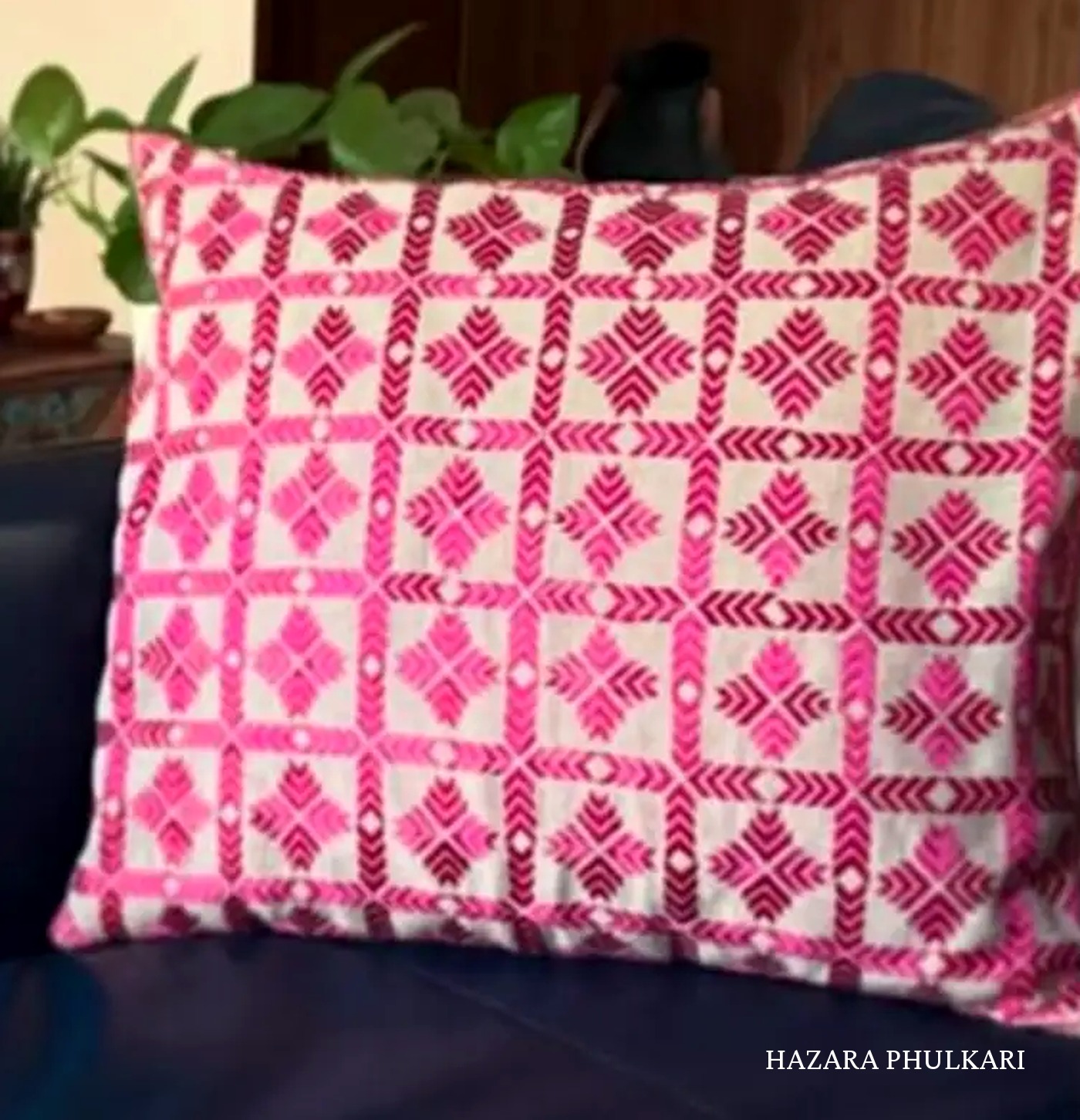 Handmade Phulkari cushion cover embroidered in pink and magenta thread with repeating diamond motifs on ivory Khaddar