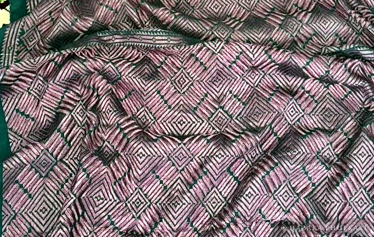 Detail of Resham silk thread embroidery showing the sheen of the stitched surface
